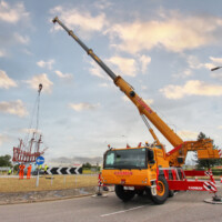 close up of mobile crane lifting steel sculpture