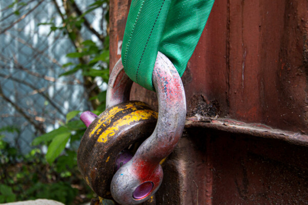 close up of large metal chain link with lifting sling attached