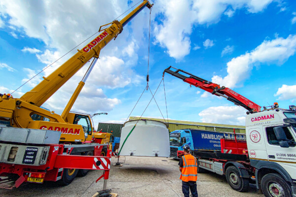 two cranes lifting a GRP tank