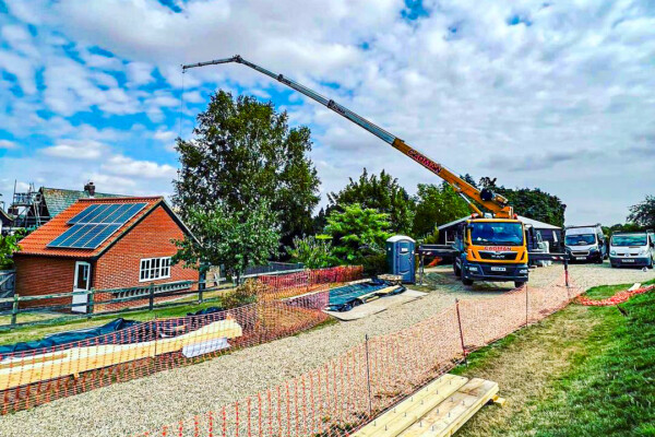 Bocker mobile truck crane lifting at residential property