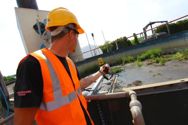 Close up of a crane operator using a remote controlled device to operate a grab