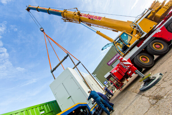 Mobile crane lifts acoustic enclosure with specialist lifting equipment