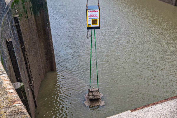 Specialist grab attachment for dredging at ports is used on a mobile crane